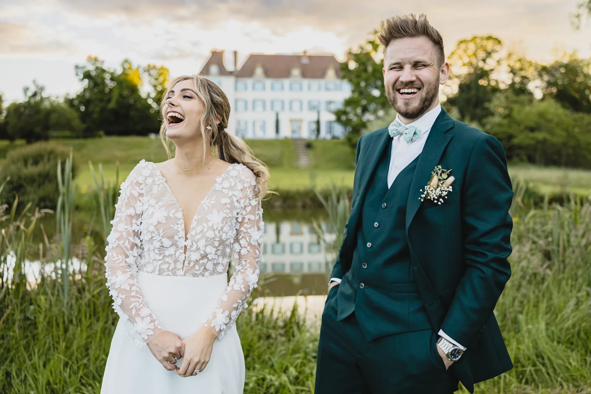 newlyweds-laughing-chateau-pond.webp