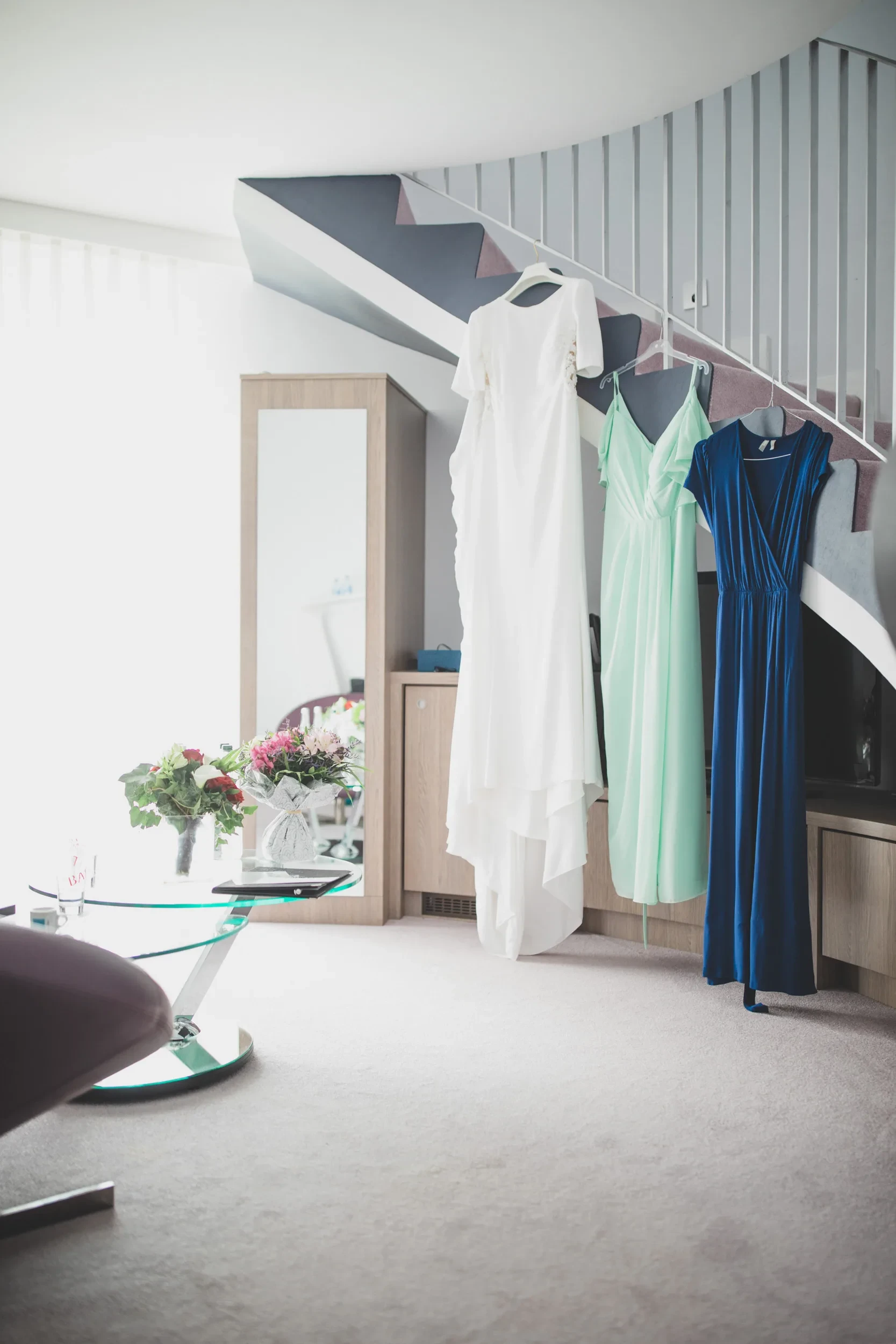 wedding-dress-bridesmaids-hanging-staircase.webp
