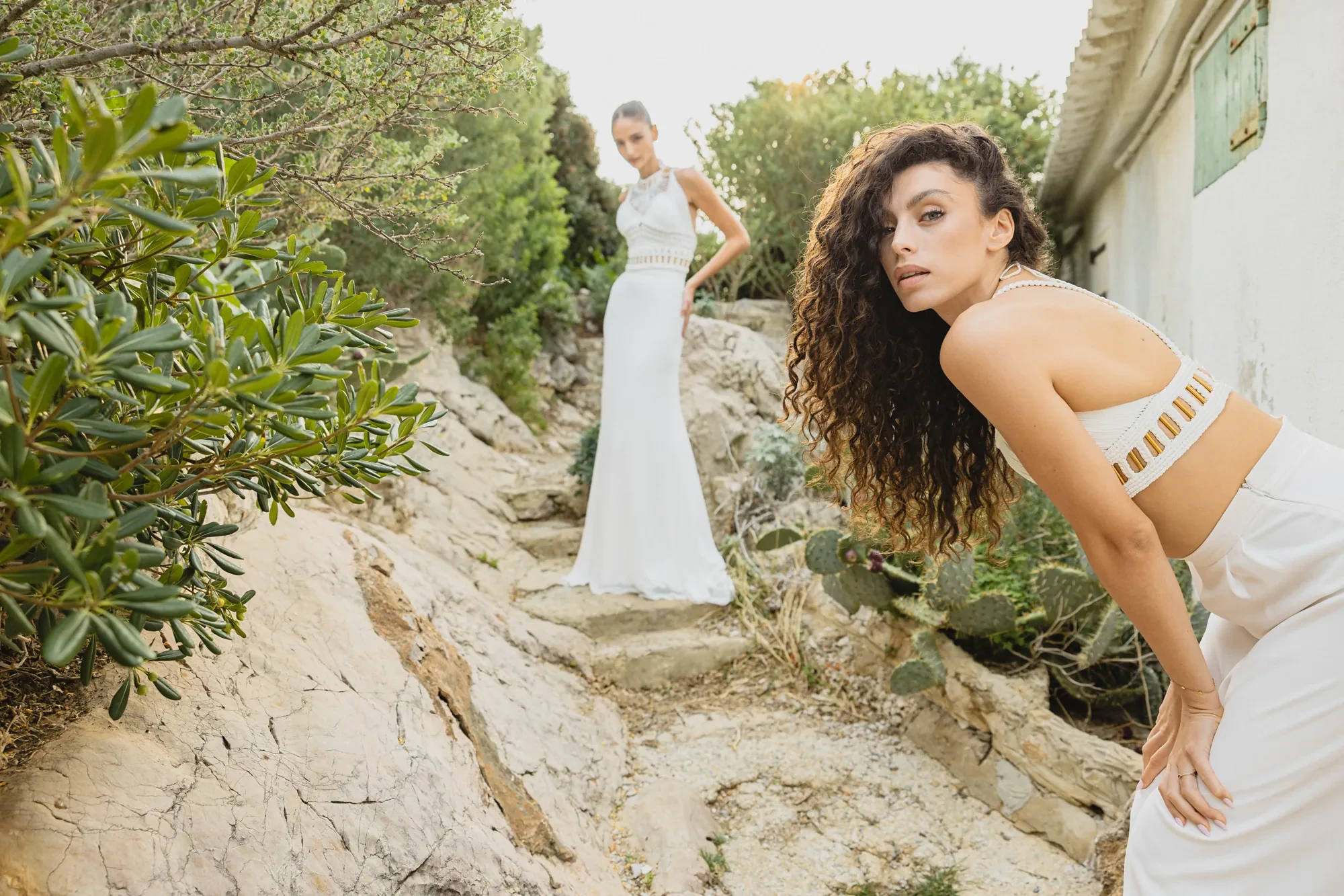two-brides-rocky-path-mediterranean.webp two-brides-rocky-path-mediterranean.webp