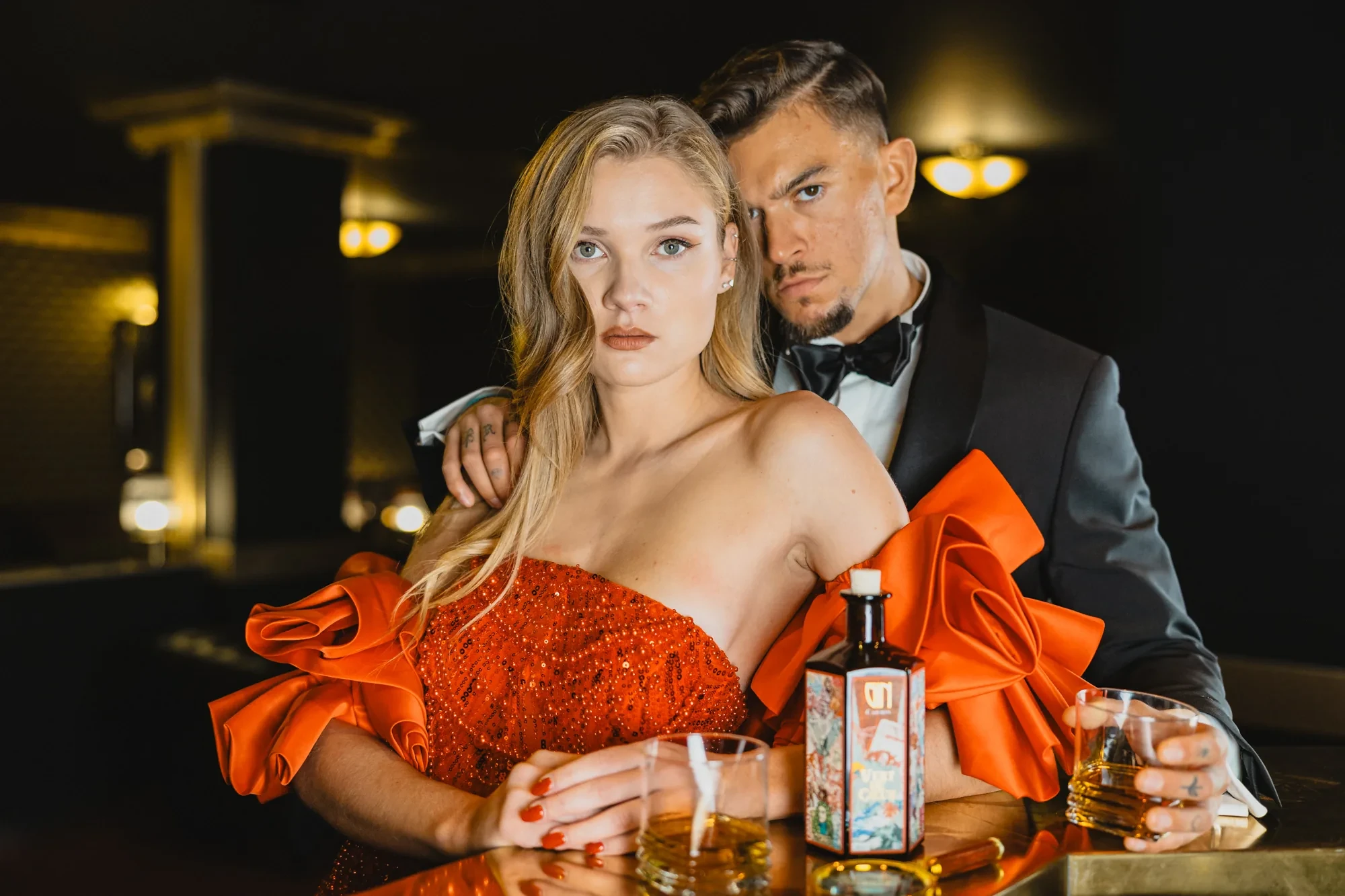 glamour-couple-bar-orange-dress-tuxedo.webp