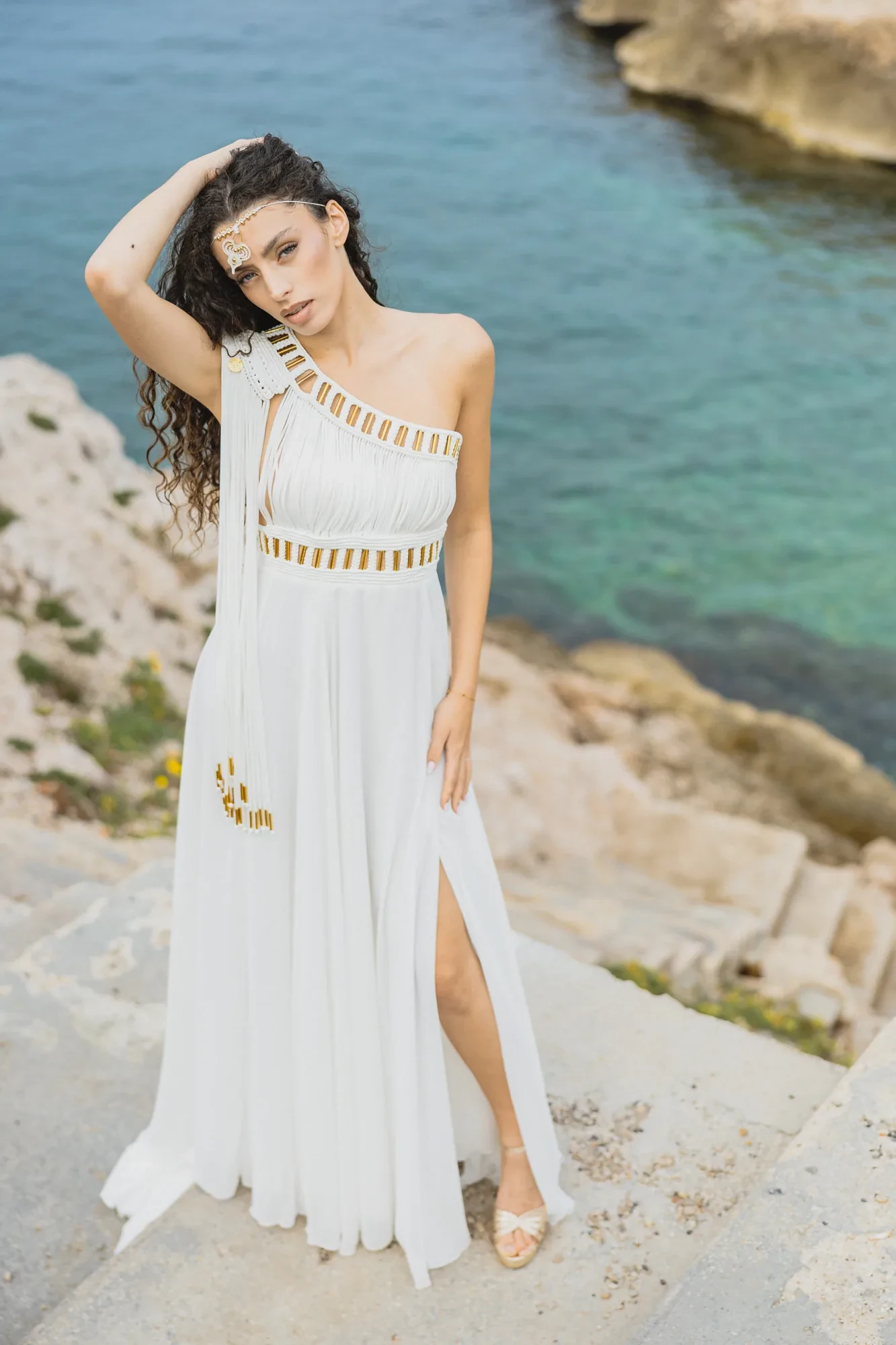 bride-white-dress-cliff-sea.webp
