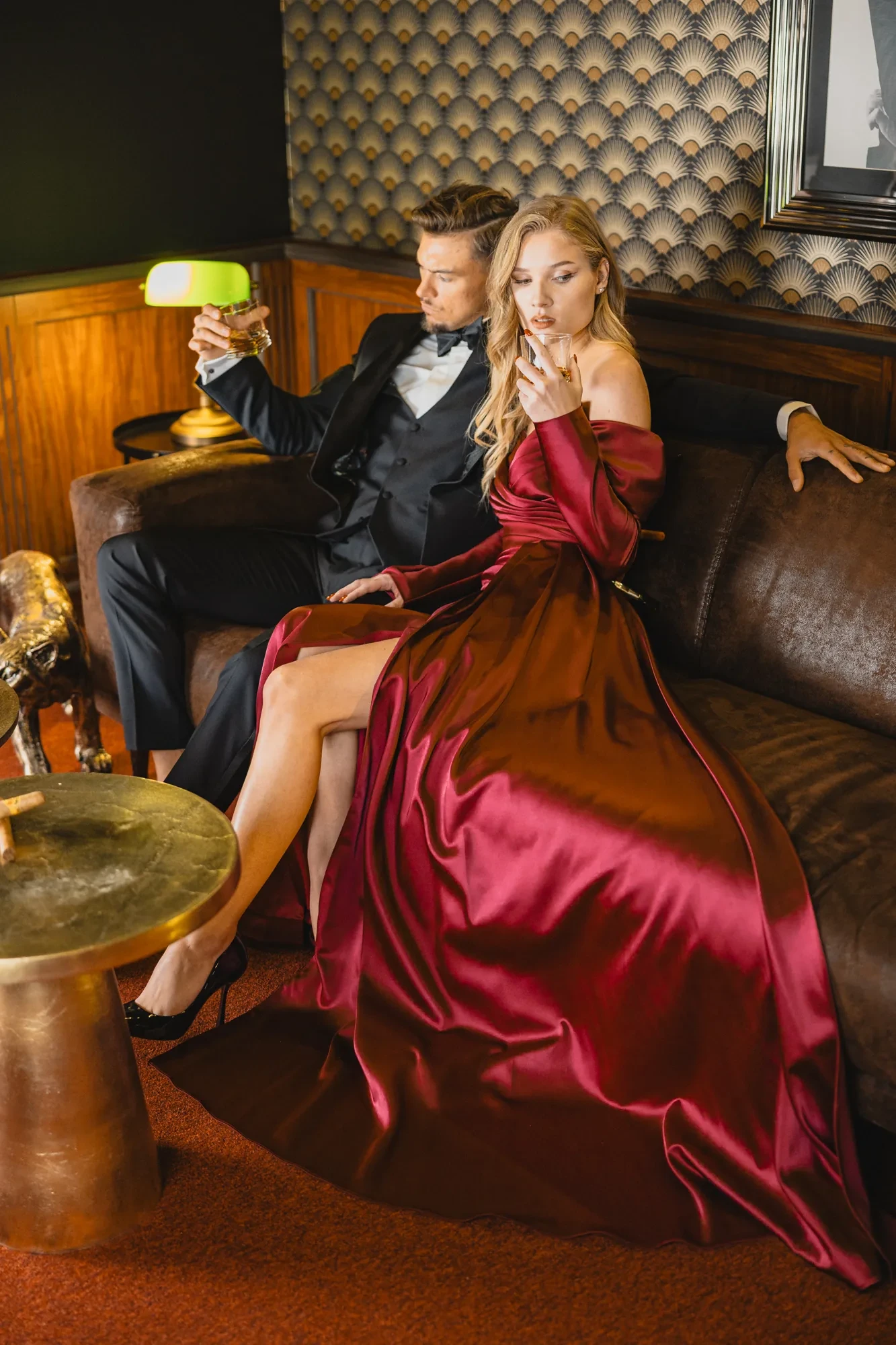 Cannes Wedding Luxury Hotel Guide for 2026 Celebrations 3 glamour-couple-sofa-burgundy-satin-dress.webp